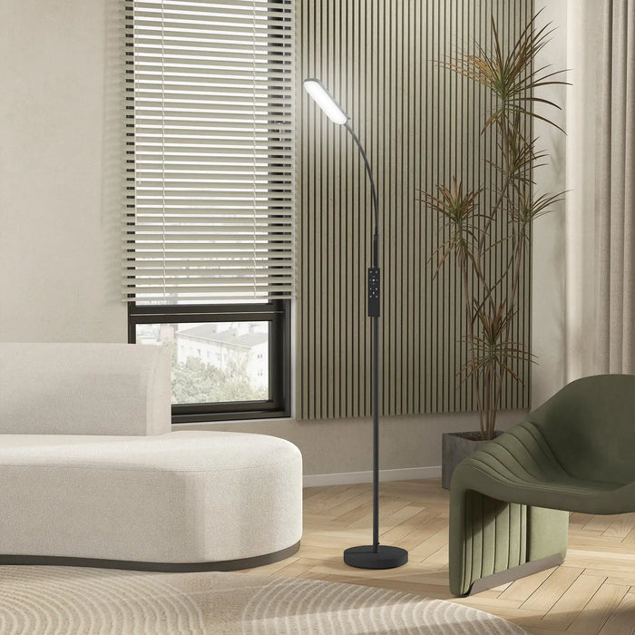 Modern living room with a floor lamp, white sofa, and green chair.