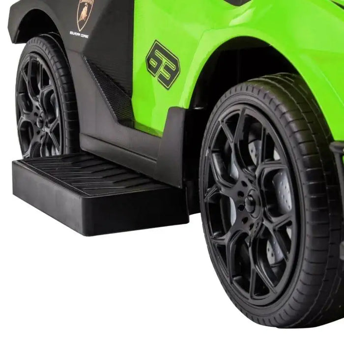 close-up of green Essenza SCV12 ride-on car with black wheels and side step