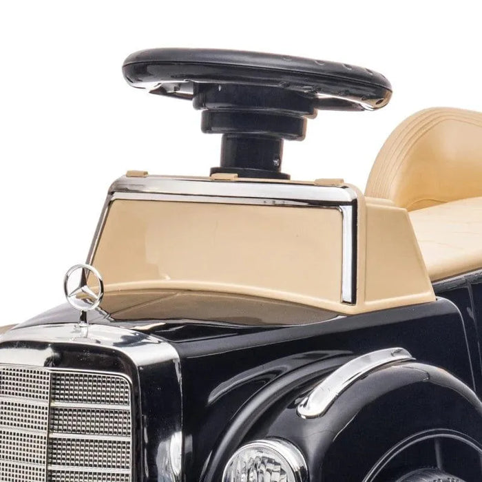 Mercedes-Benz 300S kids sliding car with steering wheel and beige seat, close-up view