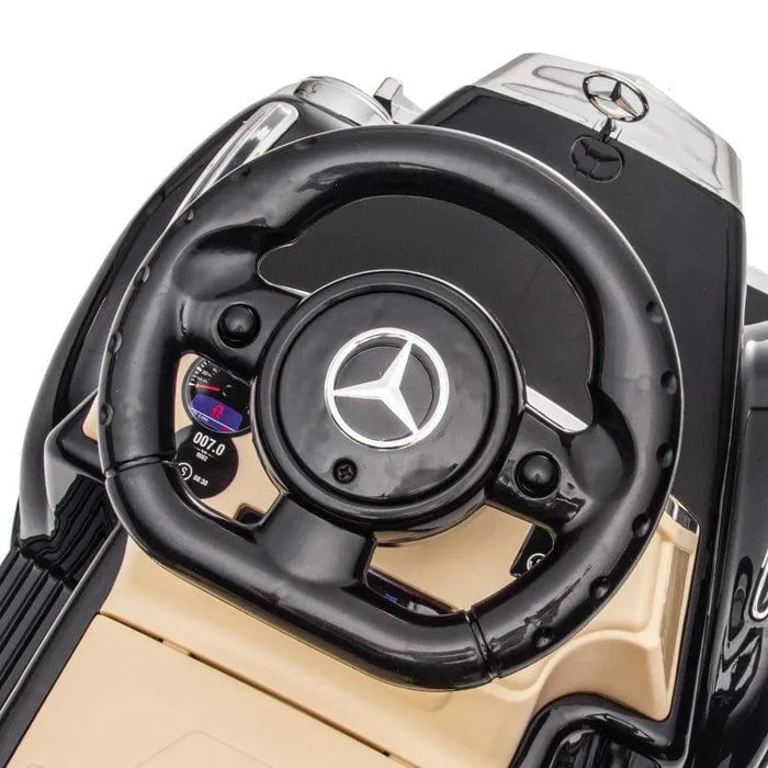 Close-up of black Mercedes-Benz 300S kids sliding car steering wheel and dashboard
