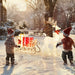 Two children in winter clothing playing with a reindeer and sleigh decoration in a snowy outdoor setting.