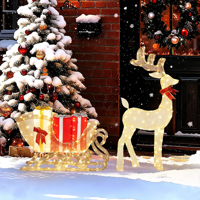 Decorative Christmas scene with a lit-up reindeer, sleigh, and tree in front of a fireplace.