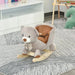 Grey plush bear rocking horse with bow on a striped rug in a child's playroom