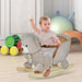 Toddler riding a grey plush bear rocking horse in a bright playroom