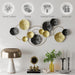 Decorative wall art with gold and black circular elements on a white wall, featuring icons and text about product qualities.