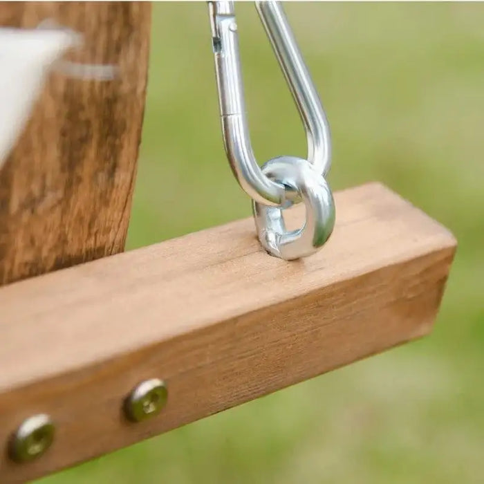 Close-up of teak and larch wood loveseat swing chair metal attachment outdoors