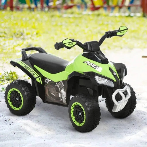 Green toddler ride-on quad bike ATV with black wheels on outdoor grass and sand