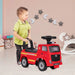 Child playing with a red toy fire truck in a room with decorative stars on the wall.