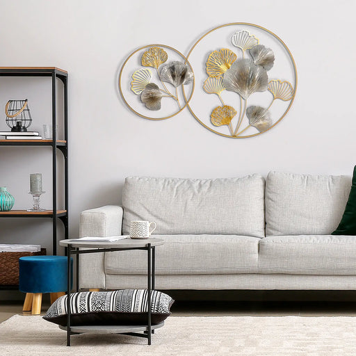 Living room with a gray sofa, decorative wall art, and a small table.