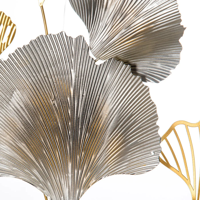 Decorative metallic leaves in gold and silver on a white background