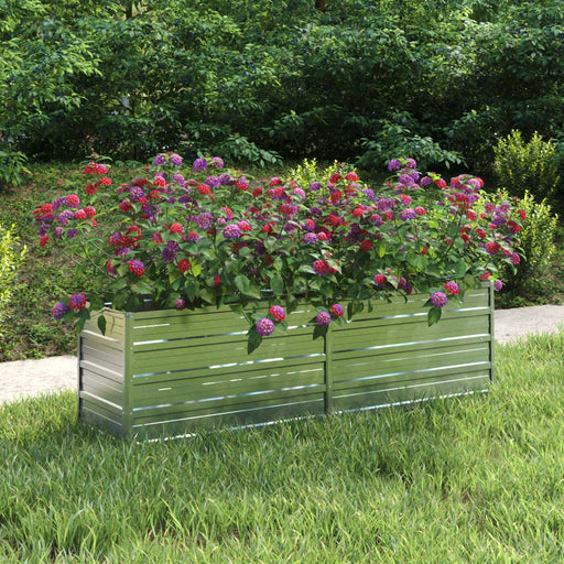 Metal raised garden bed with colorful flowers in a grassy outdoor yard