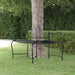 Black steel wrap-around tree bench with decorative backrest in a garden setting