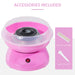 Pink cotton candy maker with accessories on a white background