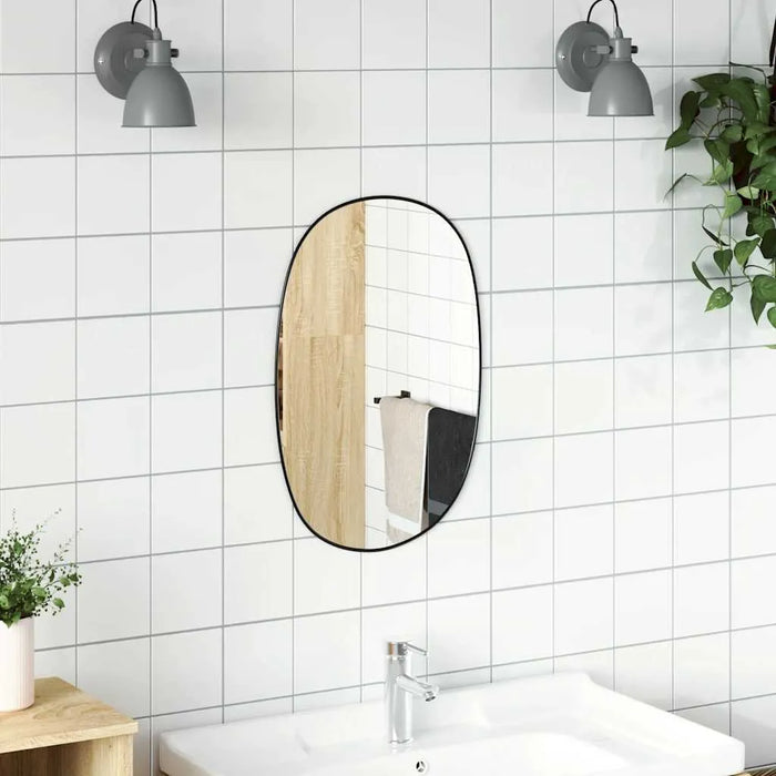 Bathroom with white tiled walls, a round mirror, and a sink.