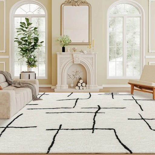 Living room with a white rug featuring black abstract patterns, a fireplace, and decorative elements.