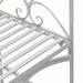 Close-up of antique white metal garden bench with curved armrest and slatted seat