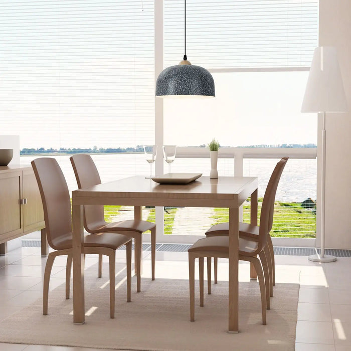 Dining area with wooden table and chairs in a bright room with large windows.