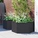 Anthracite modular raised garden planters with white flowers and greenery against a brick wall on patio