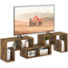 Rustic brown modular TV stand with open shelves holding decor, books, and electronics supporting large TV