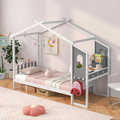 Children's room with a white house-shaped bed, pink bedding, and toys.
