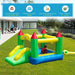 Outdoor multi-colour bouncy castle with slide on grass, child playing, modern house in background