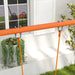 Orange swing set frame with ropes in a garden near a window and green plants