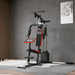 Home gym equipment with red and black design on a gray floor.