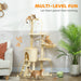 Multi-level beige cat tree with three ginger cats playing and lounging in a cozy living room