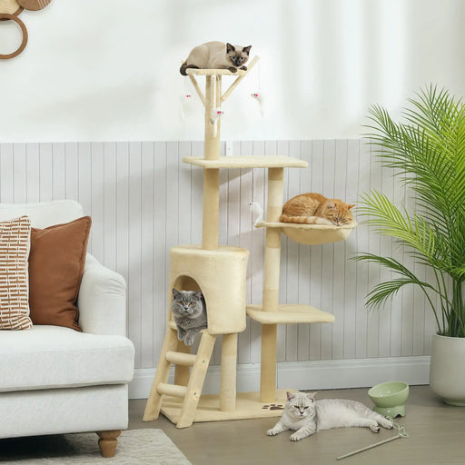 Four cats lounging on a beige multi-level cat tree in a modern living room with white walls and green plant