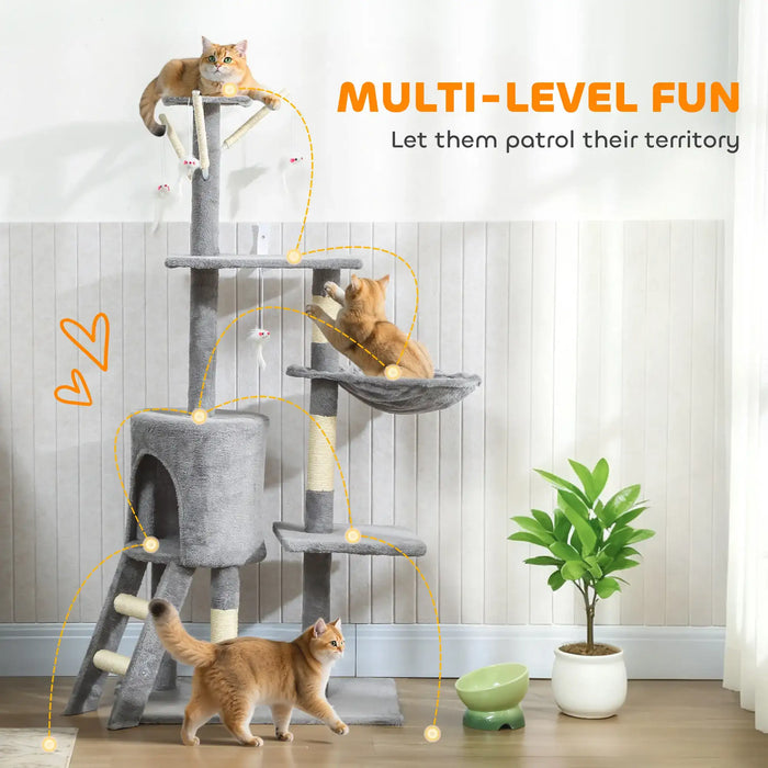 Multi-level gray cat tree with three orange cats playing, a green plant, and a food bowl in a bright room