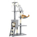 Gray multi-level cat tree with three cats playing and resting on different platforms