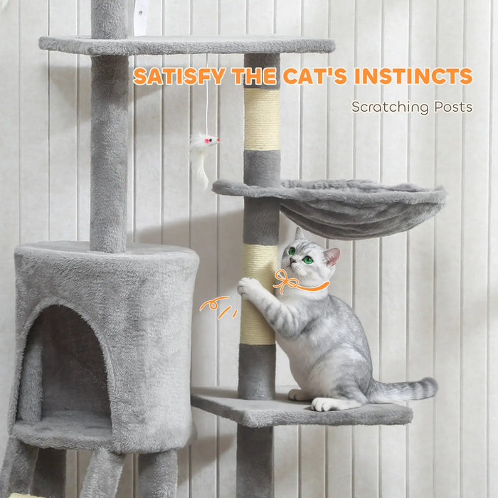 Gray and white cat scratching a sisal post on a multi-level gray cat tree with a hanging toy