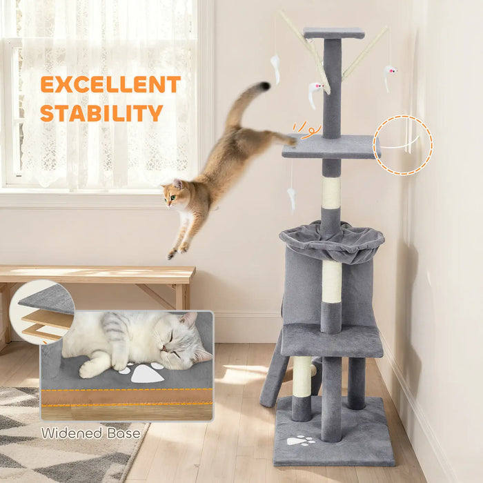 Gray multi-level cat tree with scratching posts and hanging toys in bright room with jumping cat