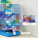 Blue multi-level pet cage with colorful tunnels, food dish, and water bottle on white table
