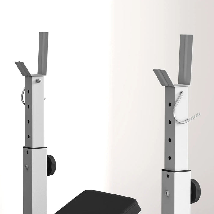 Gym squat rack with weight bench on a white background