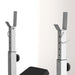 Gym squat rack with weight bench on a white background