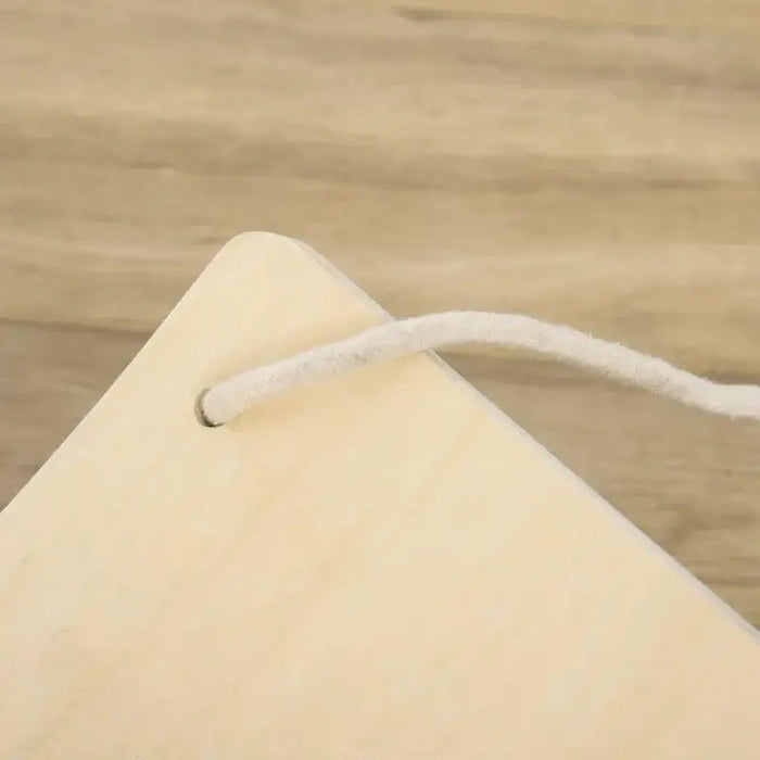 Close-up of a natural beech wood wobble board corner with white rope on wood floor