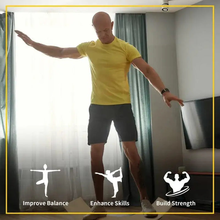 Man balancing on natural beech wood wobble balance board indoors for exercise and fitness