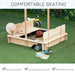 Natural wood sandbox with benches, adjustable canopy, toys and books on artificial grass