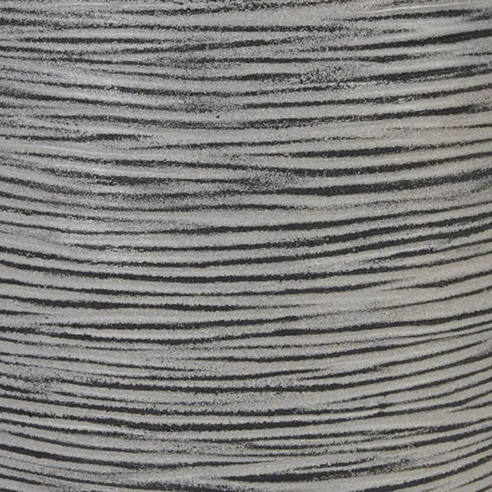Anthracite ribbed flower pot surface with horizontal textured lines, close-up view