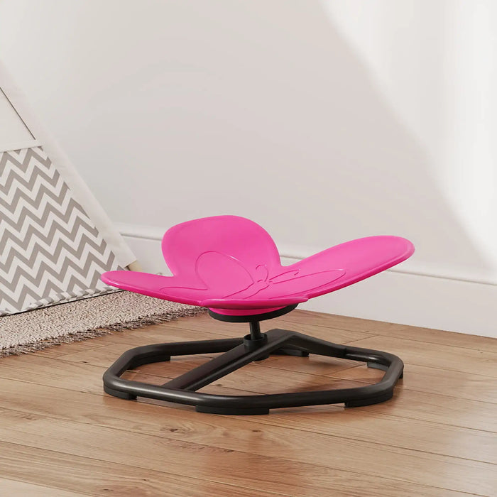 Pink and black chair on a wooden floor with a white wall in the background