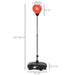 Adjustable freestanding red punching bag with black base and height measurements