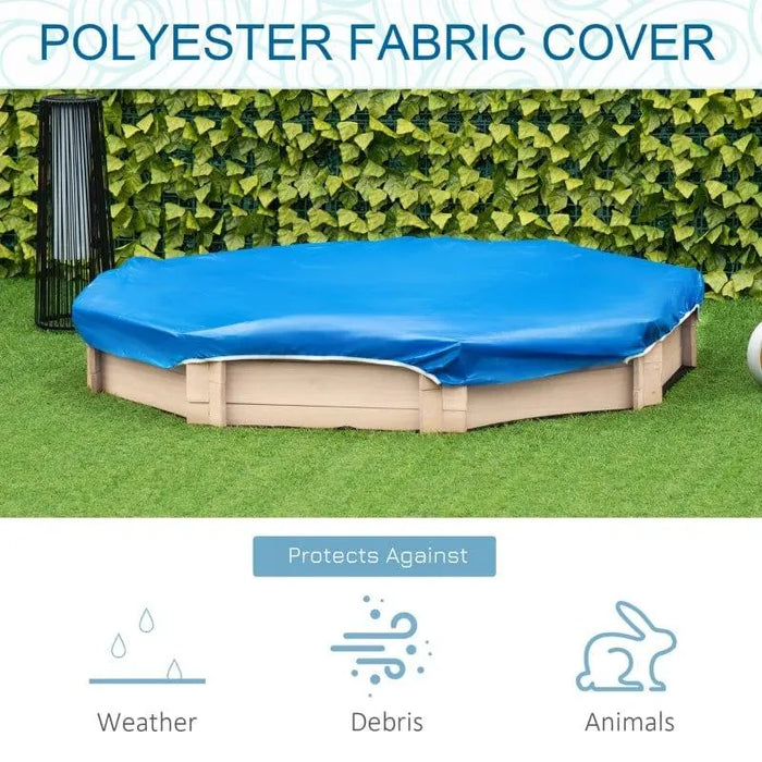 A round, sand-colored Outsunny outdoor kids sandbox covered with a blue polyester fabric cover set against a backdrop of a lush green hedge. Icons indicate protection against weather, debris, and animals.