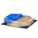 A wooden kids sandbox filled with sand, covered partially with an Outsunny Sandbox with Cover, placed on a black mat on a white background.