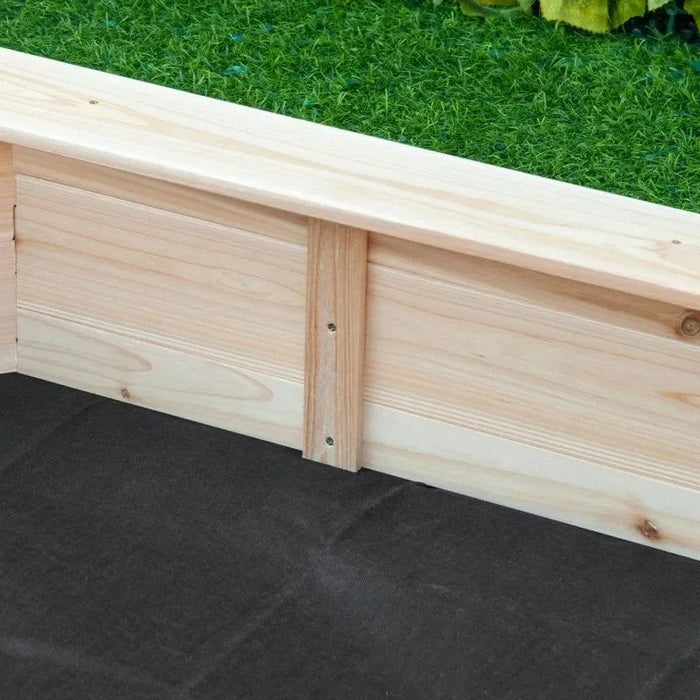 Close-up view of the corner of a wooden Outsunny raised garden bed with a bottomless design on a green grass background, featuring natural wood planks joined together and a black fabric lining underneath.