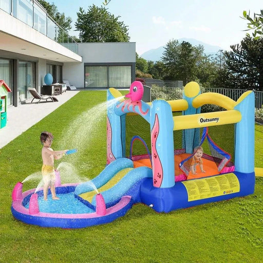 Kids playing on Outsunny octopus inflatable bouncy castle with slide and water sprayer in a yard