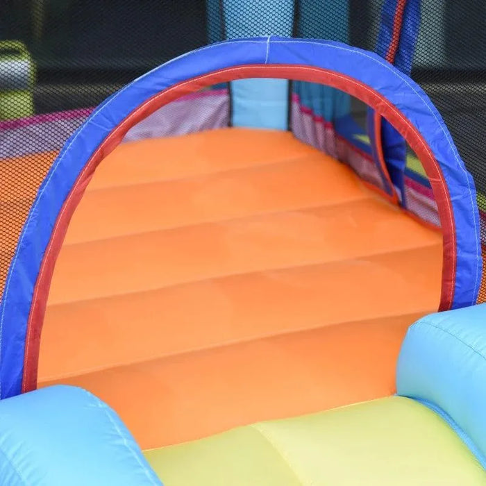Colorful inflatable bouncy castle interior with orange floor and mesh safety walls