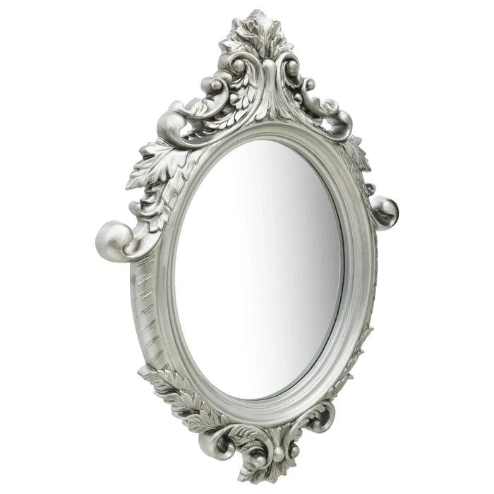 Ornate oval wall mirror with silver castle-style frame and intricate vintage floral detailing