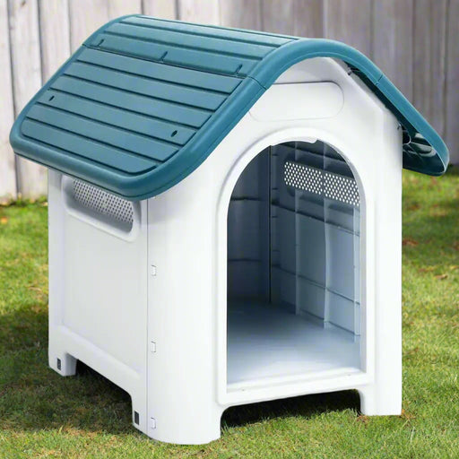 Blue and white outdoor dog house with ventilation and raised floor on grass