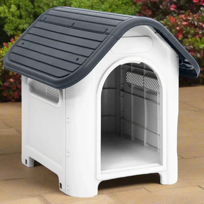 Grey and white outdoor dog house with ventilation and raised floor on patio